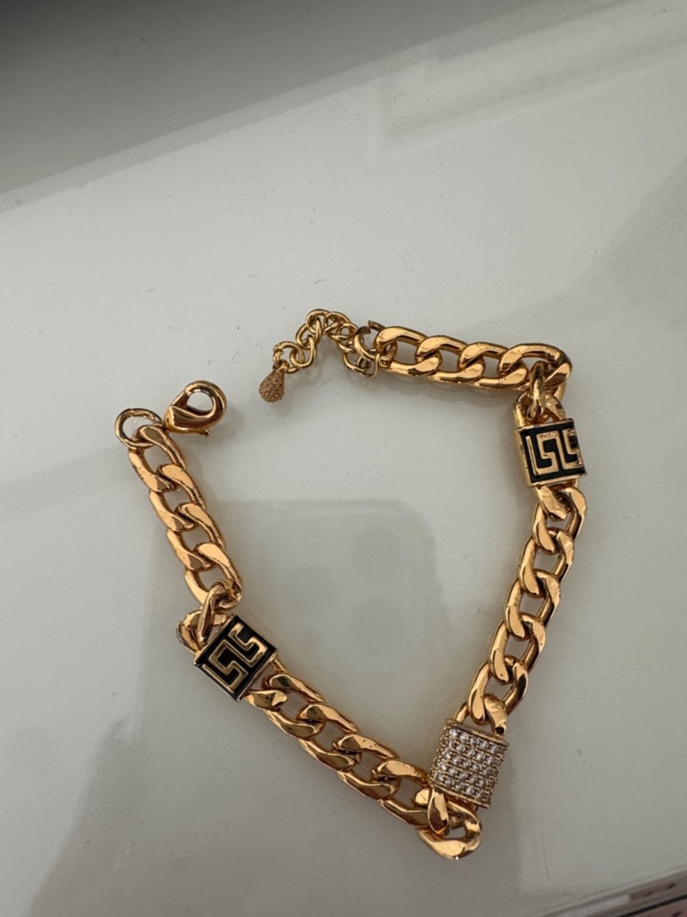 Gold-Tone Chain Bracelet with Black Emblem and Pavé Charm